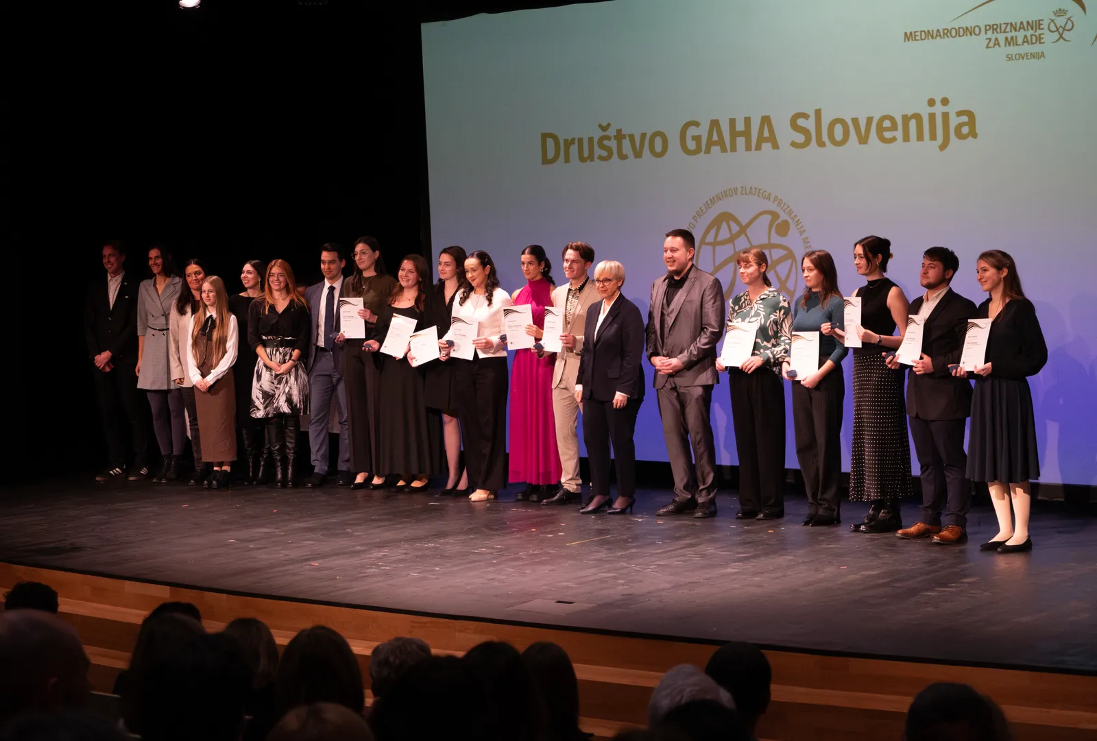 I stand on stage with the GAHA Slovenia Gold MEPI recipients and organizers