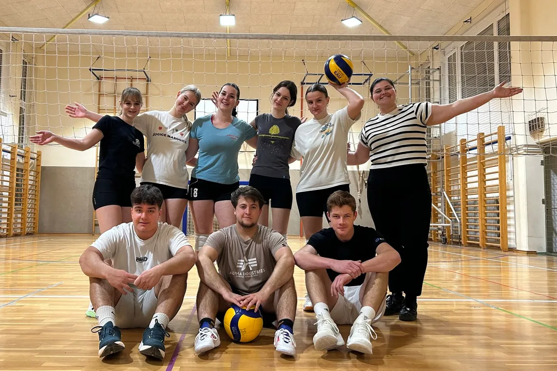 I sit with friends after playing volleyball together