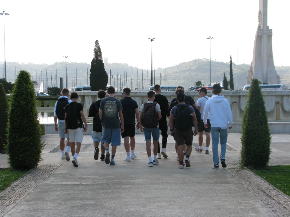 Student group walking near the waterfront during a cultural visit in Lisbon
